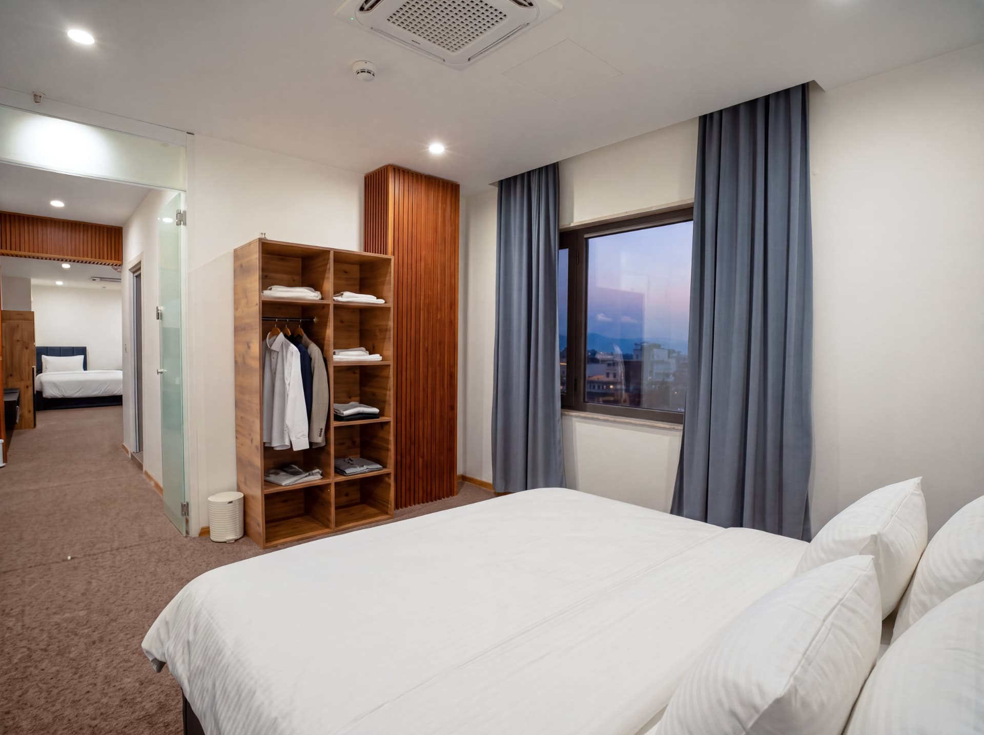 King Suite bedroom with walk-in wardrobe at dusk