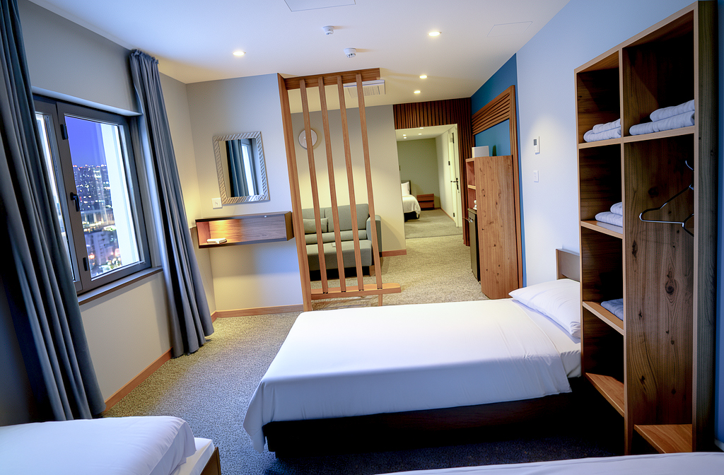 King Suite bedroom with timber screen and city view